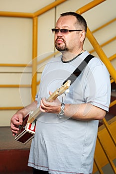 Man playing his cigar box guitar