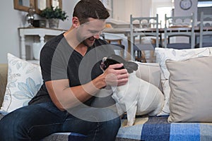 Man playing with his dog in living room