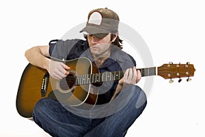 Man playing his guitar seated