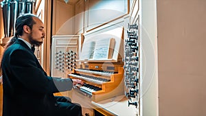 Man Playing On The Keyboard Of An Organ