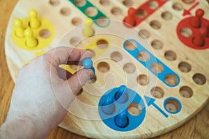 Man playing Ludo board game.