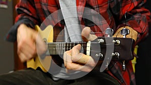 Man playing music on a ukulele.