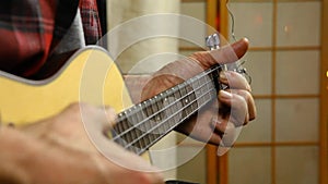 Man playing music on a ukulele.