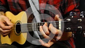 Man playing music on a ukulele.