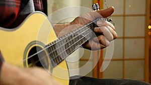 Man playing music on a ukulele.