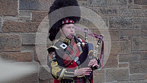 Man playing musical instrument bagpipe instrument, traditional Scottish clothes