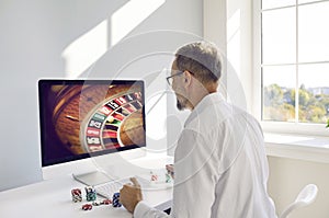 Man playing online casino gambling game on computer