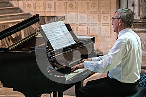 Man playing piano in a cathedral