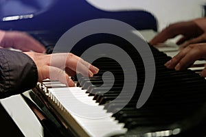 Man playing on Piano, focused on the hand