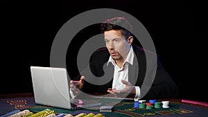 Man playing poker online and losing. Close up