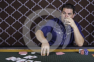 A man playing poker sitting at a table