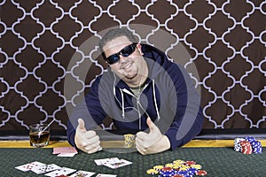 A man playing poker sitting at a table