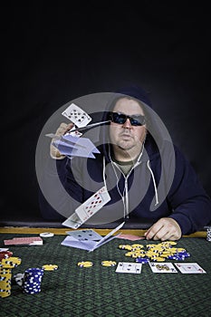 A man playing poker sitting at a table