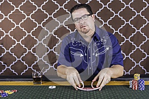 A man playing poker sitting at a table