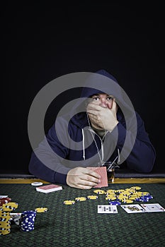 A man playing poker sitting at a table