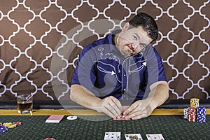 A man playing poker sitting at a table