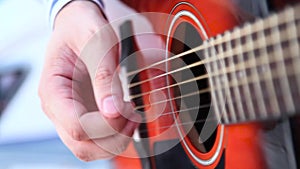 Man playing red acoustic guitar