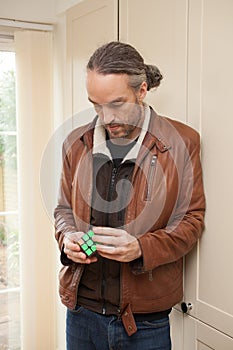 A man playing with a Rubix cube