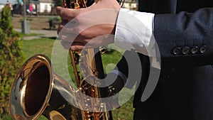 A man playing saxophone jazz music. Saxophonist in dinner jacket play on golden saxophone. Live performance. concept of