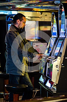 Man playing at slot machines