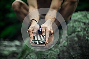 Man playing a small thumb piano