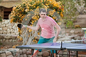 The man playing table tennis in pink shirt. Sport. Activa life.