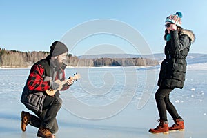 Man playing ukelele for his girlfriend