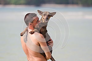 The man plays with abacuses on the beach.