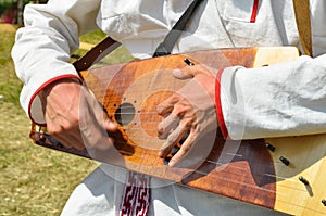 Man plays an ancient traditional Russian musical instrument - gusli