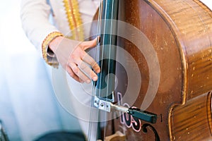 The man plays a contrabass.