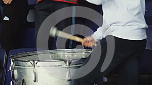 Man plays drum on spectator seats at sports competitions