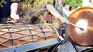 Man plays with Drumsticks on African djembe cow`s skin