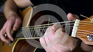 A man plays an electric and acoustic guitar