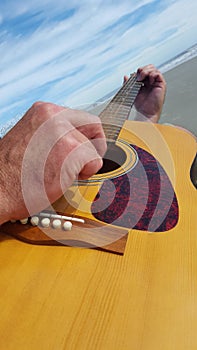 Man plays guitar at the beach