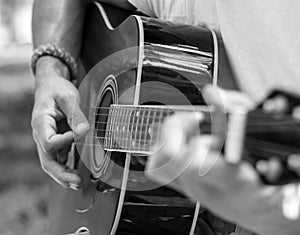 Man plays guitar in black and white tones