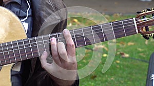 A man plays the guitar in the park