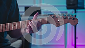 Man plays guitar in professional music studio. Man plays a musical instrument. Musician records his composition in a music Studio