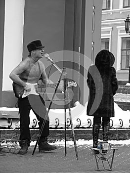 A Man Plays Guitar Shirtless in Russia