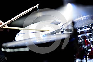 man plays musical percussion instrument with sticks closeup on a black background, a musical concept with the working