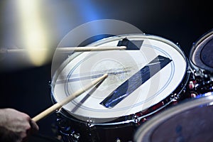 man plays musical percussion instrument with sticks closeup on a black background, a musical concept with the working