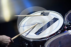 Man plays musical percussion instrument with sticks closeup on a black background, a musical concept with the working