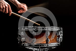 man plays musical percussion instrument with sticks a musical concept with the working drum