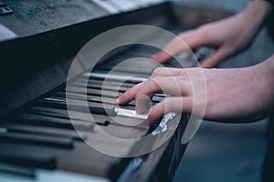 A man plays the old vintage piano. close-up. film noise emulation.