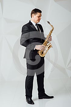 A man plays the saxophone close up