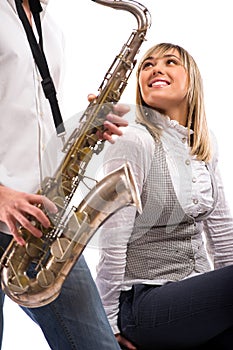 Man plays the saxophone for girlfriend