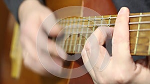 A man plays a six-string acoustic guitar. Plays a fight, takes chords