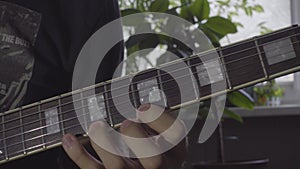 A man plays a solo on an electric guitar