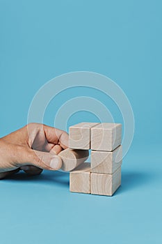 man plays with toy blocks