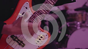 A Man Plays On A White Electric Guitar In A Club