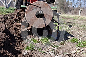 Man plowing   land with   cultivator